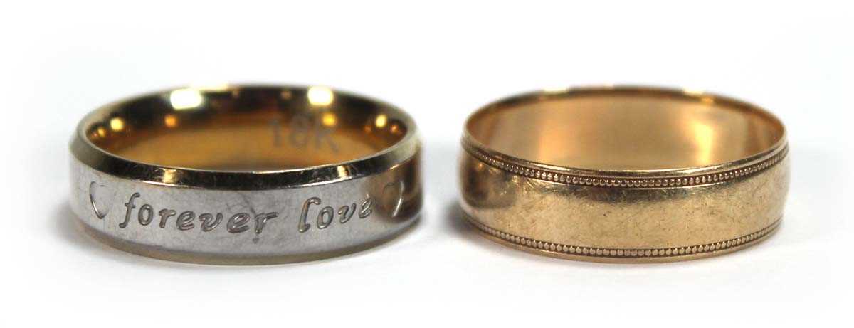 Lot 560 - A 9ct yellow gold wedding band with beaded...