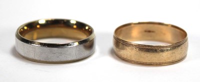 Lot 560 - A 9ct yellow gold wedding band with beaded...