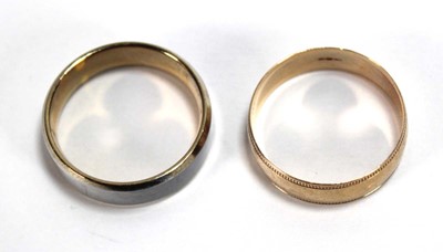 Lot 560 - A 9ct yellow gold wedding band with beaded...