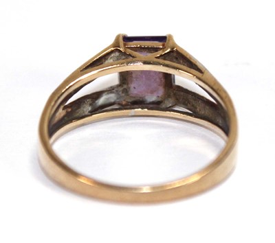 Lot 559 - A 9ct yellow gold ring set oval purple stone...