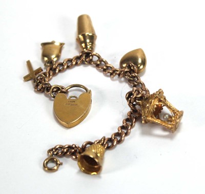 Lot 574 - A 9ct yellow gold curblink bracelet with heart...