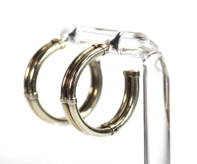 Lot 575 - A pair of 9ct yellow gold double hoop earrings,...