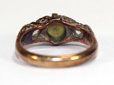 Lot 576 - An 18ct yellow gold ring set cabochon tigers...