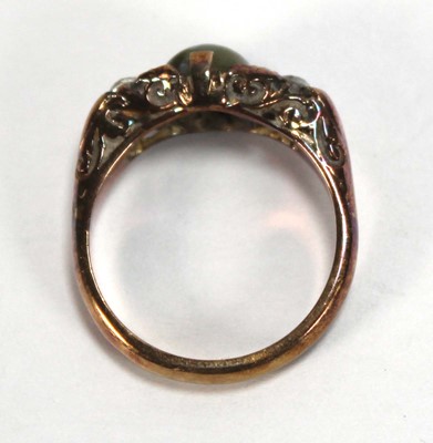 Lot 576 - An 18ct yellow gold ring set cabochon tigers...