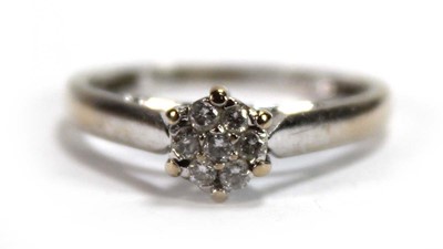 Lot 581 - An 18ct white gold cluster ring set seven...