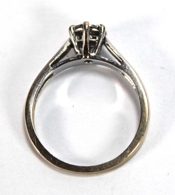 Lot 581 - An 18ct white gold cluster ring set seven...