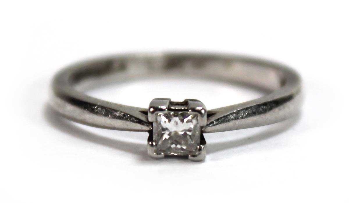 Lot 583 - A platinum ring set princess cut diamond in a...