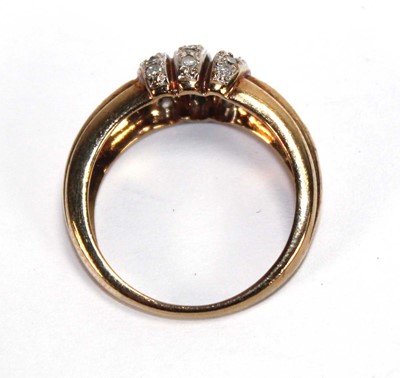 Lot 585 - A 9ct yellow gold ring set three bands of...