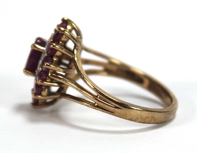 Lot 588 - A 9ct yellow gold cluster ring set three tiers...