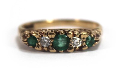 Lot 589 - A 9ct yellow gold ring set three graduated...