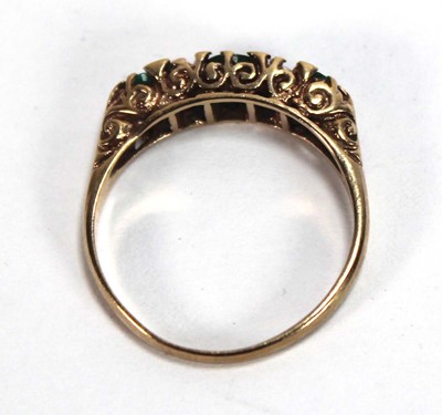 Lot 589 - A 9ct yellow gold ring set three graduated...