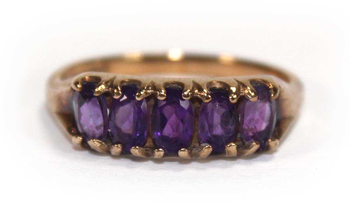 Lot 592 - A 9ct yellow gold ring set five oval amethyst,...