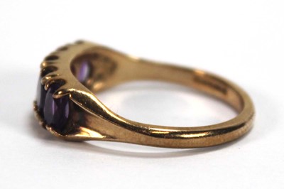 Lot 592 - A 9ct yellow gold ring set five oval amethyst,...