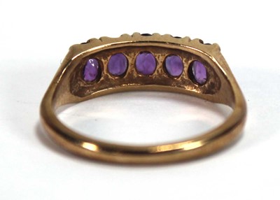 Lot 592 - A 9ct yellow gold ring set five oval amethyst,...