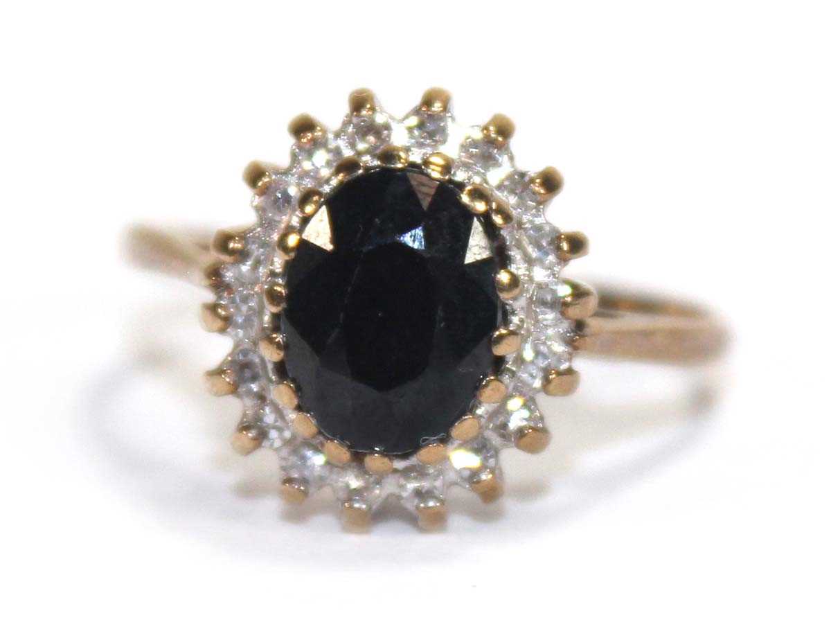 Lot 593 - A 9ct yellow gold sapphire and diamond cluster...