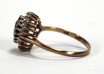 Lot 593 - A 9ct yellow gold sapphire and diamond cluster...