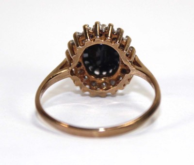 Lot 593 - A 9ct yellow gold sapphire and diamond cluster...