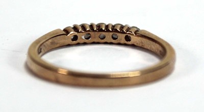 Lot 594 - A 9ct yellow gold ring set five small diamonds...
