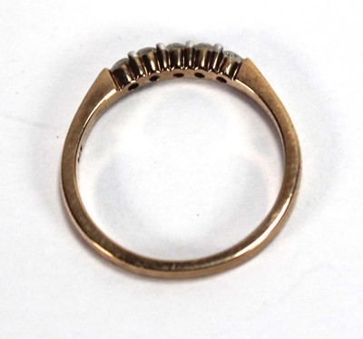 Lot 594 - A 9ct yellow gold ring set five small diamonds...