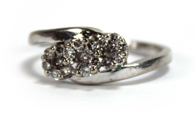 Lot 595 - A 9ct white gold crossover ring set three...