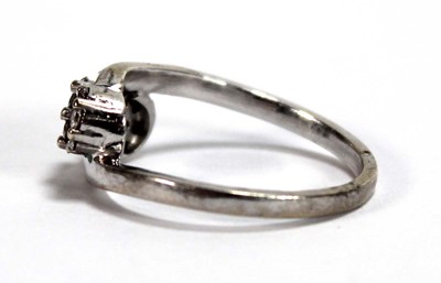 Lot 595 - A 9ct white gold crossover ring set three...