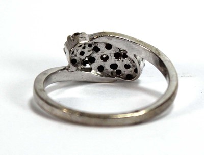 Lot 595 - A 9ct white gold crossover ring set three...