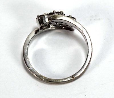 Lot 595 - A 9ct white gold crossover ring set three...