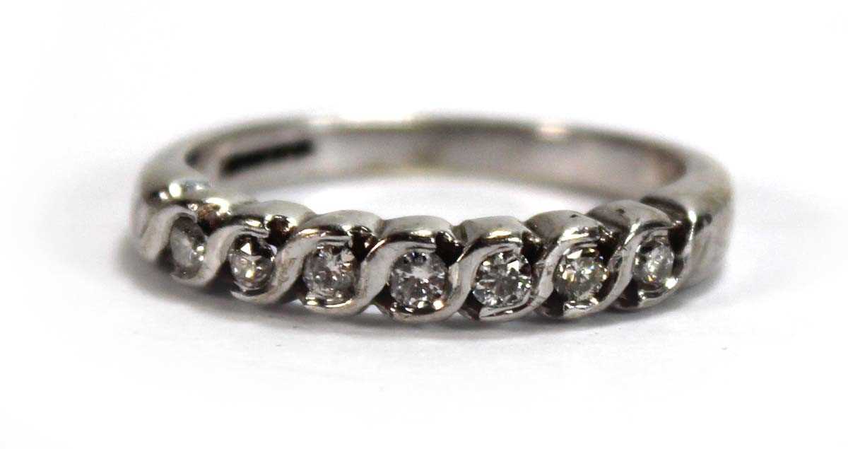 Lot 596 - A 9ct white gold half eternity ring set seven...