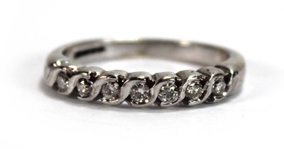 Lot 596 - A 9ct white gold half eternity ring set seven...