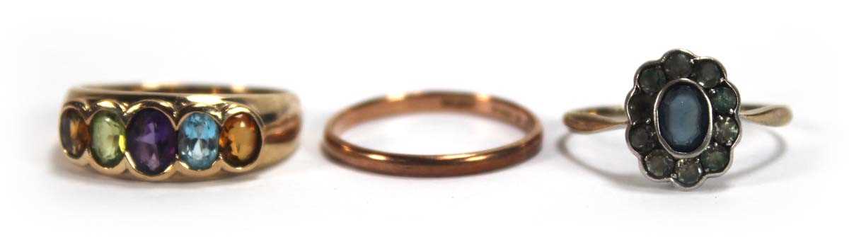 Lot 599 - A 9ct yellow gold ring set five oval semi...