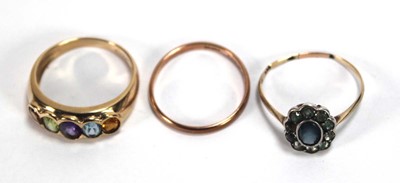 Lot 599 - A 9ct yellow gold ring set five oval semi...