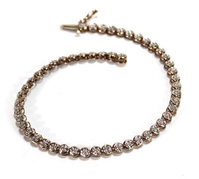 Lot 602 - A 9ct yellow gold tennis bracelet set small...