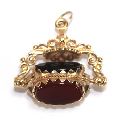 Lot 606 - A 9ct yellow gold swivel fob set hardstone, w....