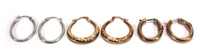 Lot 608 - A pair of 9ct white gold hollow oval ear hoops,...