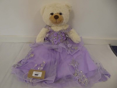 Lot 3026 - Large cream plush teddy bear wearing purple...