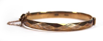 Lot 628 - A 9ct yellow gold hinged bracelet with facet...