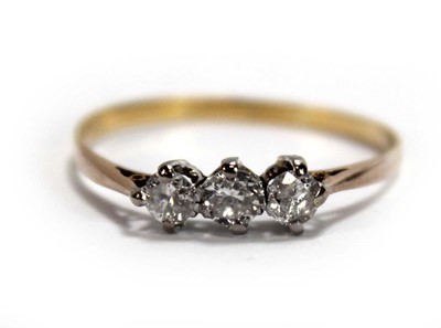 Lot 645 - A yellow metal ring set three small diamonds...