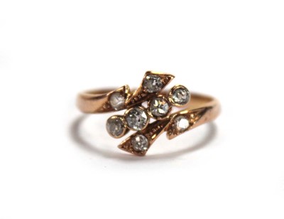 Lot 650 - A rose gold ring set eight small diamonds in a...