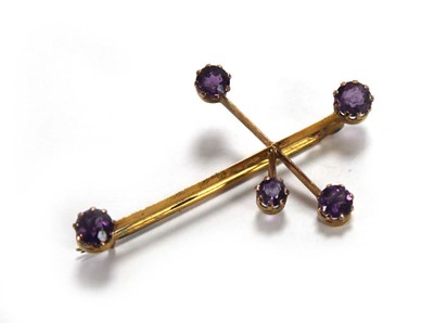 Lot 659 - A 9ct yellow gold bar brooch set five small...