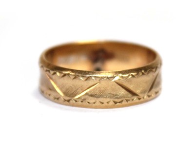 Lot 661 - An 18ct yellow gold engraved wedding band,...