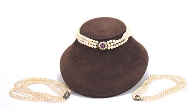 Lot 666 - A triple strand cultured pearl choker with 9ct...