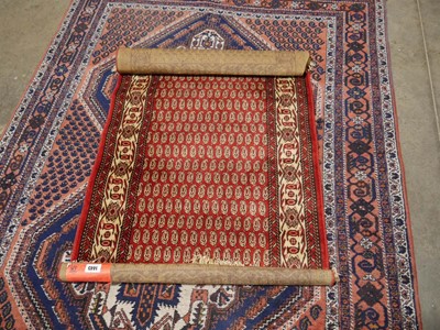 Lot 1445 - Pink, navy and beige figured and bordered rug...
