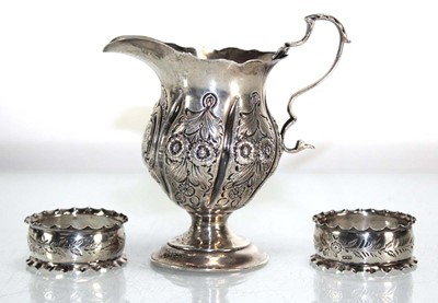 Lot 308 - A silver cream jug with repousse foliate...