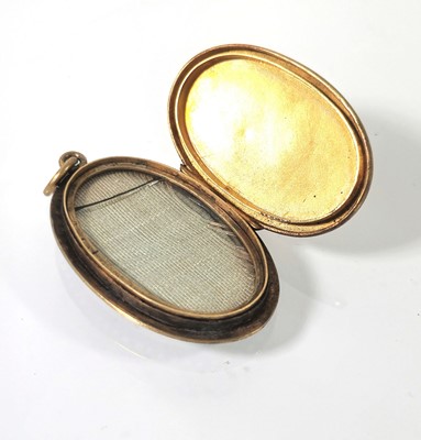 Lot 404 - A 19th century yellow metal and enamel locket...