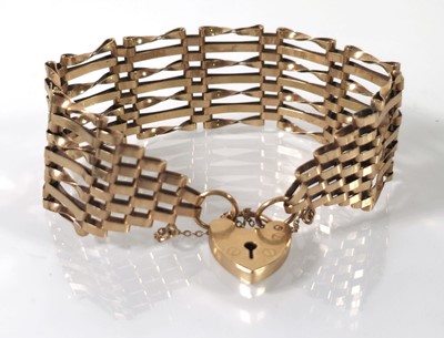 Lot 408 - A 9ct gold seven bar gate bracelet. Approx....