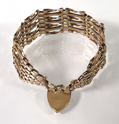 Lot 408 - A 9ct gold seven bar gate bracelet. Approx....