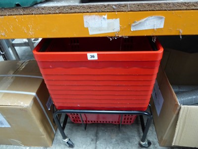 Lot 36 - Red poly shopping baskets on a mobile stand