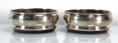 Lot 360 - A pair of silver mounted oak wine coasters of...