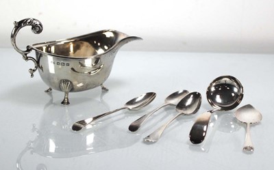 Lot 373 - A silver sauce boat with leaf capped c-scroll...