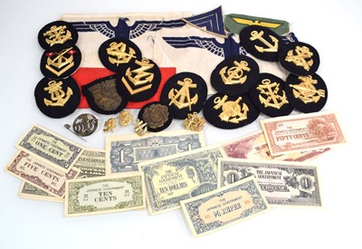 Lot 131 - A small group of cap badges, currency and...